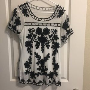 Sheer white top with black cording details